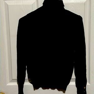 black long sleeve turtleneck. gold buttons on sleeves.